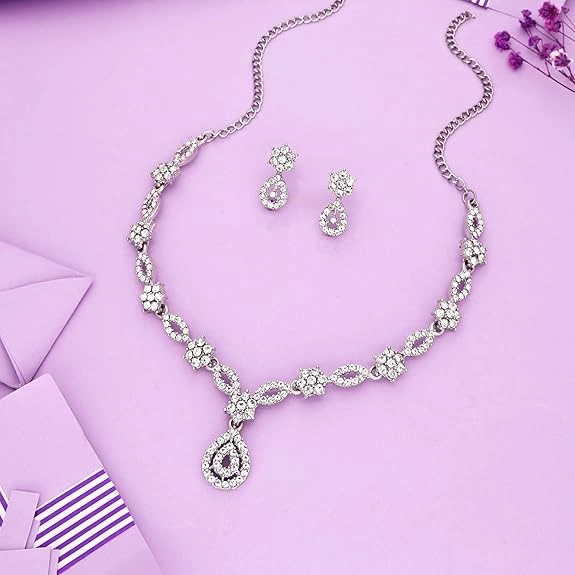 A beautiful model wearing a gold necklace and earrings.